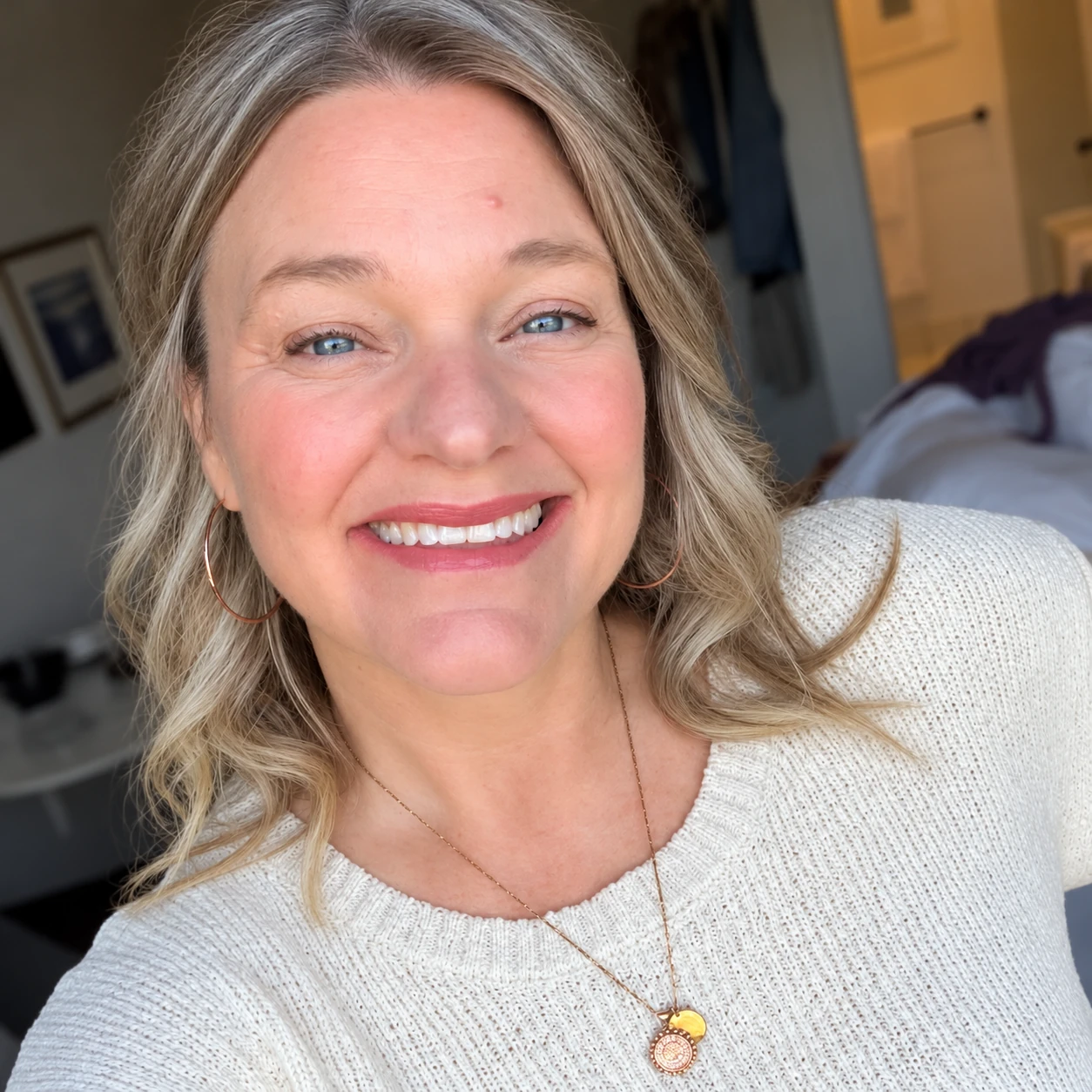 Callan Rush smiling warmly in a cream sweater