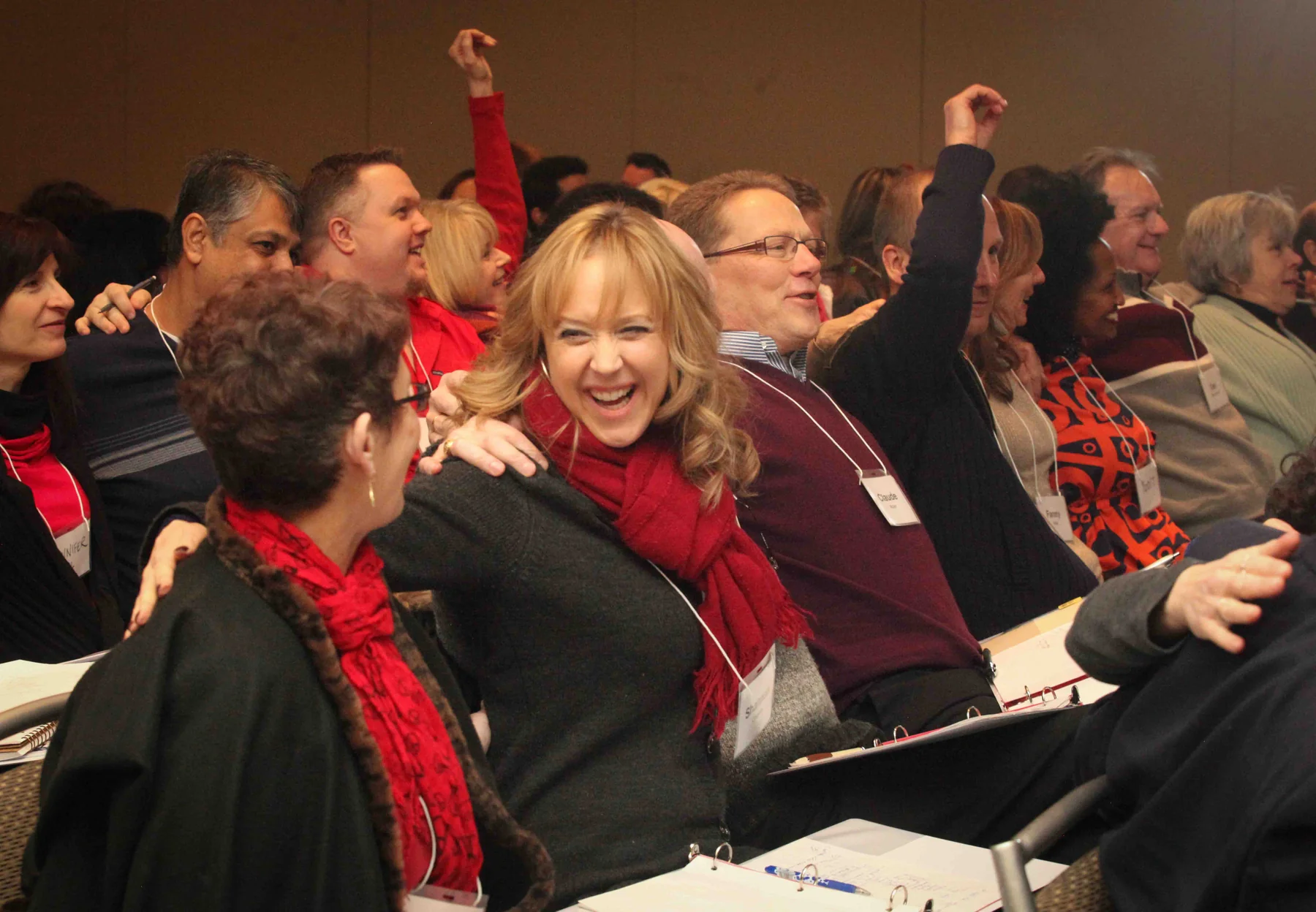 Workshop participants laughing and cheering together