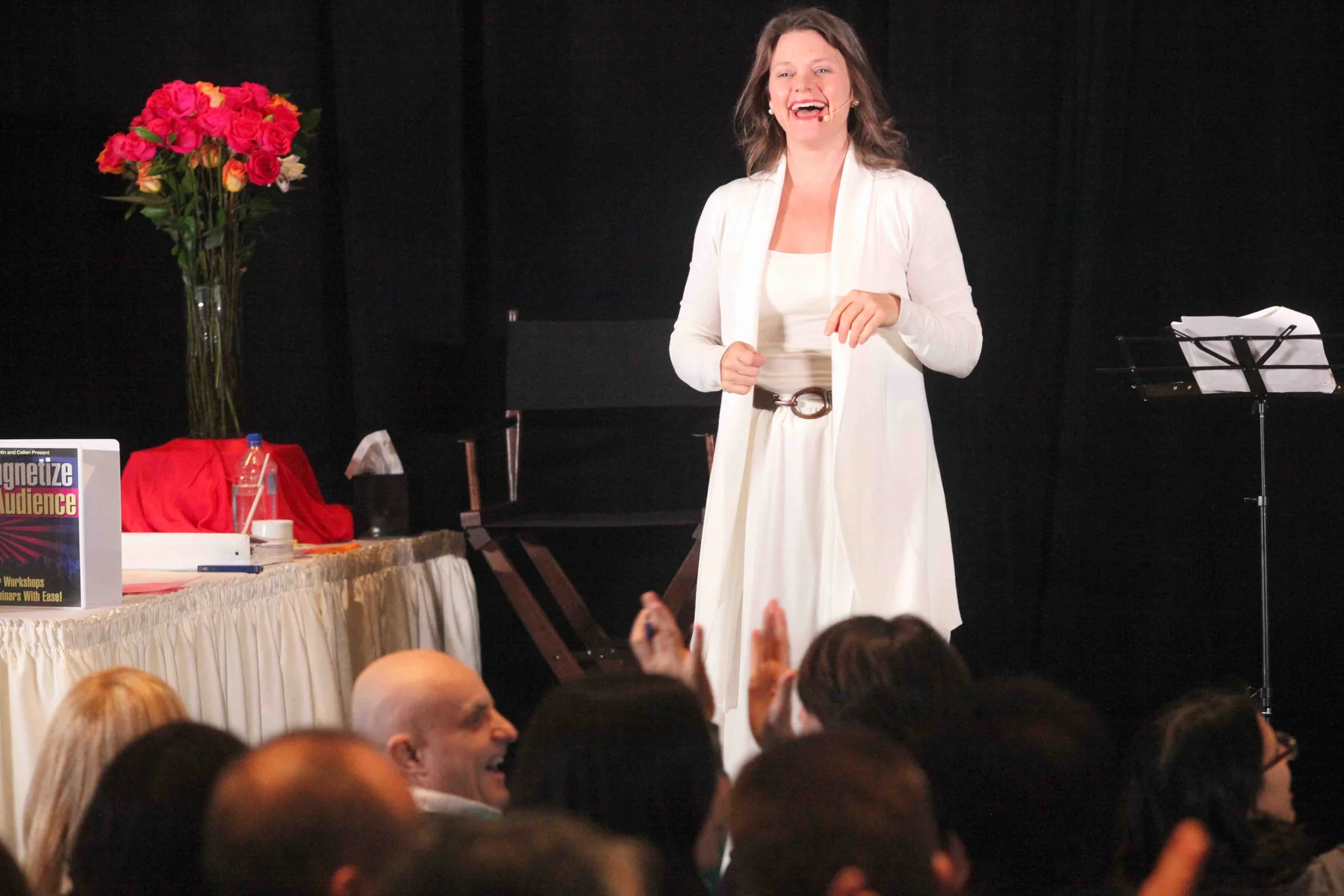 Callan Rush laughing on stage at a live workshop