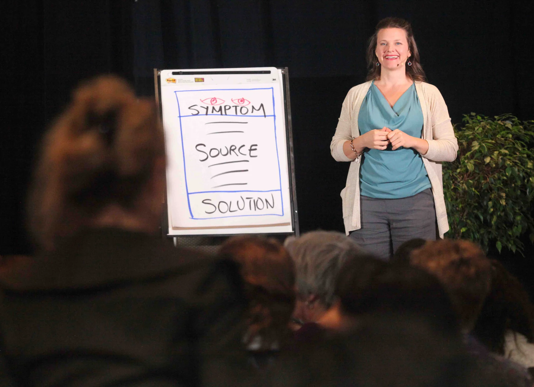 Callan teaching beside a flip chart